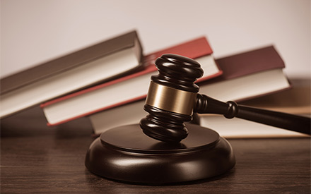 Gavel in front of a stack of books