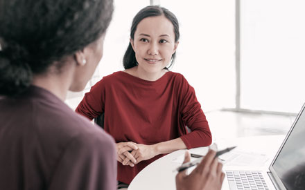 Psychologist at computer in a discussion with a student